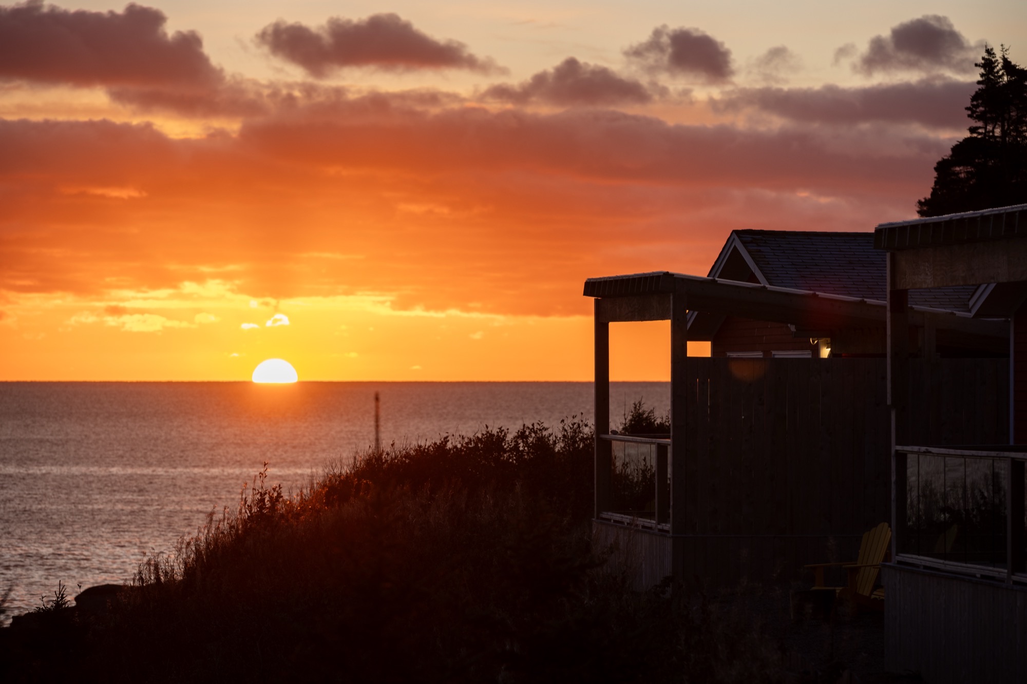 Sunset over the ocean from an oceanside cottage at Cliff's Edge Retreat
